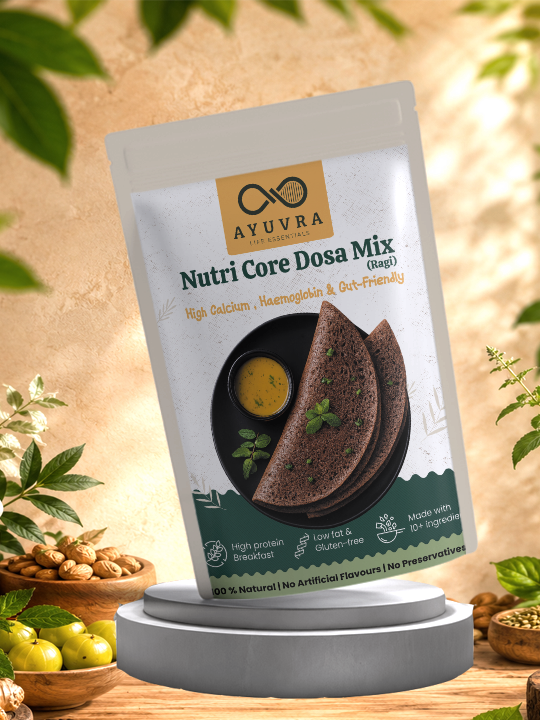 Packaging of Ayuvra Nutri Core Dosa Mix on a wooden surface with greenery in the background