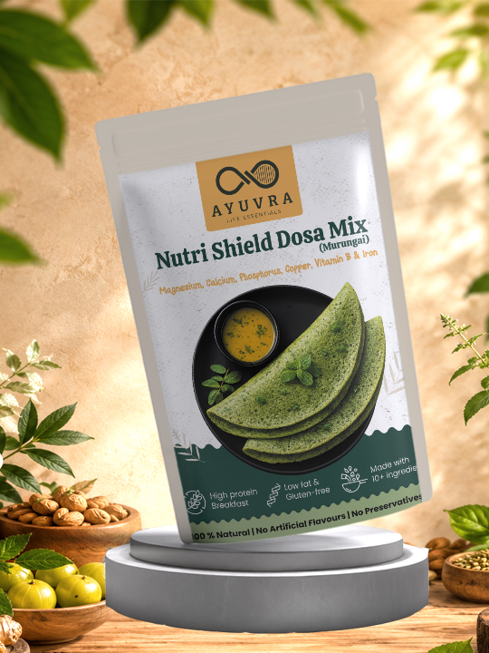 Packaging of Ayuvra Nutri Shield Dosa Mix on a wooden surface with greenery in the background