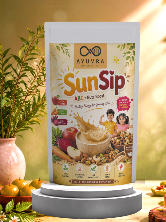 Ayuvra Sunsip ABC Nuts Boost packaging on a decorative stand with a plant and fruits in the background.